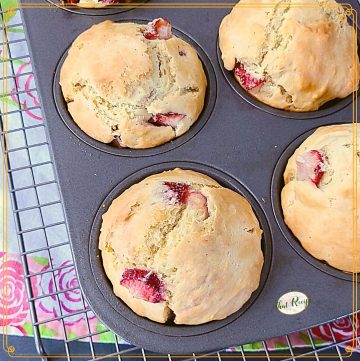 strawberry muffins in a muffin tin with text overlay "sourdough strawberry muffins"