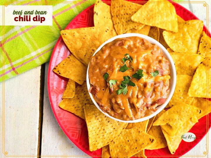 chili dip on a plate with chips and text overlay "beef and bean chili dip"