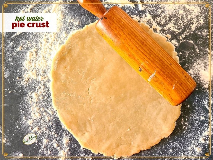 pie dough rolled out on a counter with text overlay "hot water pie crust"