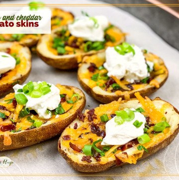 bacon and cheddar potato skins topped with sour cream and onions with text overlay "bacon and cheddar potato skins"
