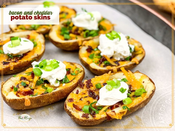 bacon and cheddar potato skins topped with sour cream and onions with text overlay "bacon and cheddar potato skins"
