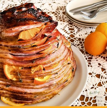 Spiral sliced ham on a plate with text overlay "orange stuffed spiral sliced ham"