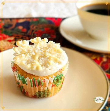 white cupcake with white chocolate snowflake on a plate