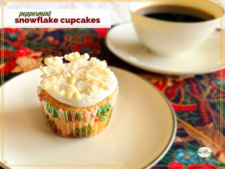 white cupcake on a plate with text overlay "peppermint snowflake cupcakes"