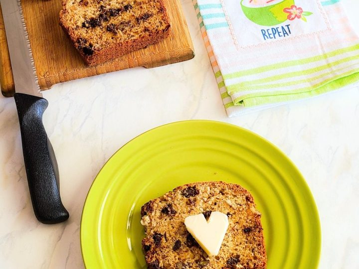 slice of chocolate pecan banana bread with loaf of bread