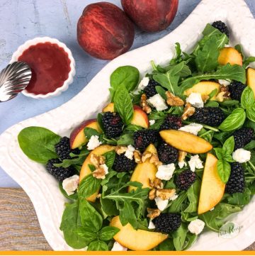 peach slices and blackberries on salad greens with blackberry dressing