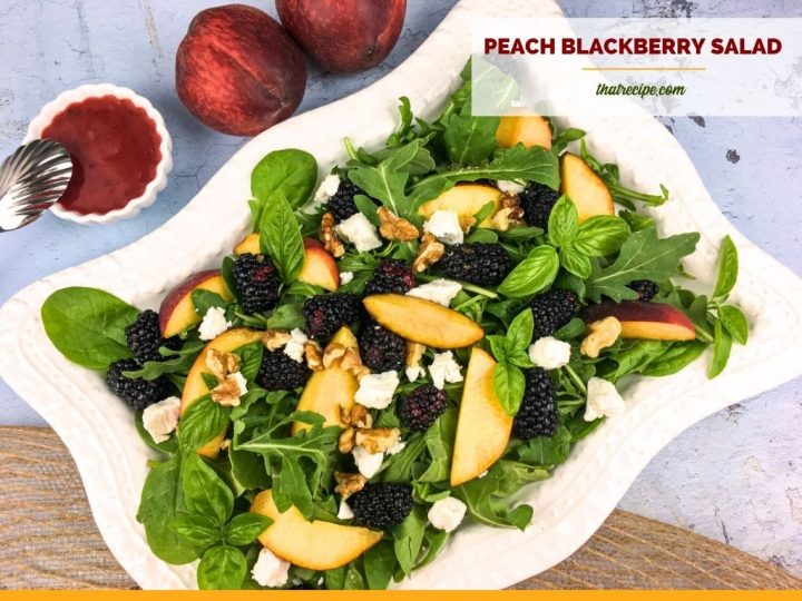 peach slices and blackberries on salad greens with blackberry dressing and text overlay "peach and blackberry salad"