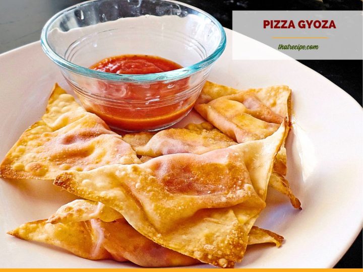 baked wontons on a plate with marinara sauce and text overlay "baked pizza gyoza"