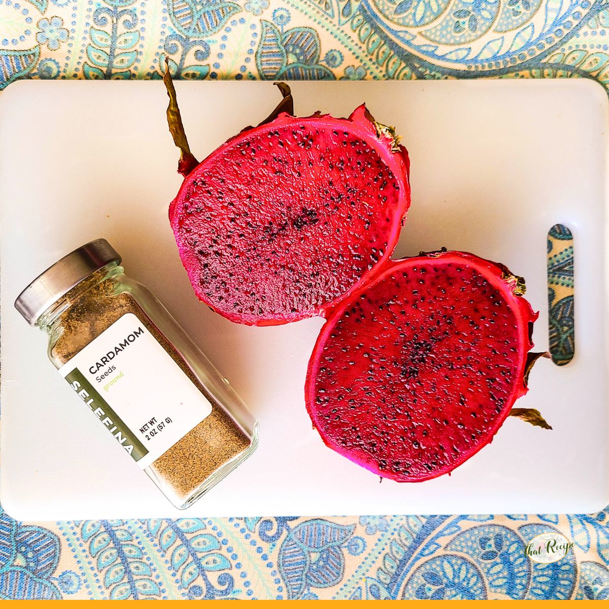 red dragon fruit with a jar of ground cardamom