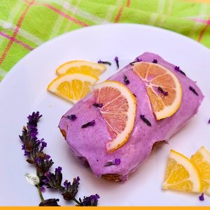 lemon pound cake with lavender glaze on a serving plate