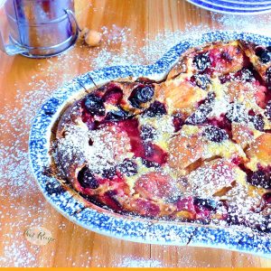 clafoutis topped with peaches, plums and cherries