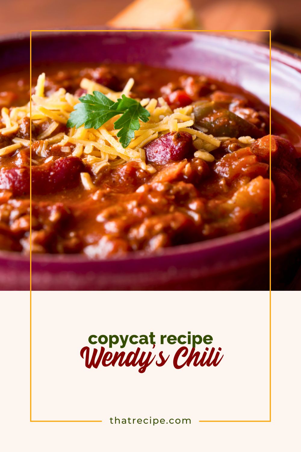 close up of a bowl of chili with beans. topped with cheese.