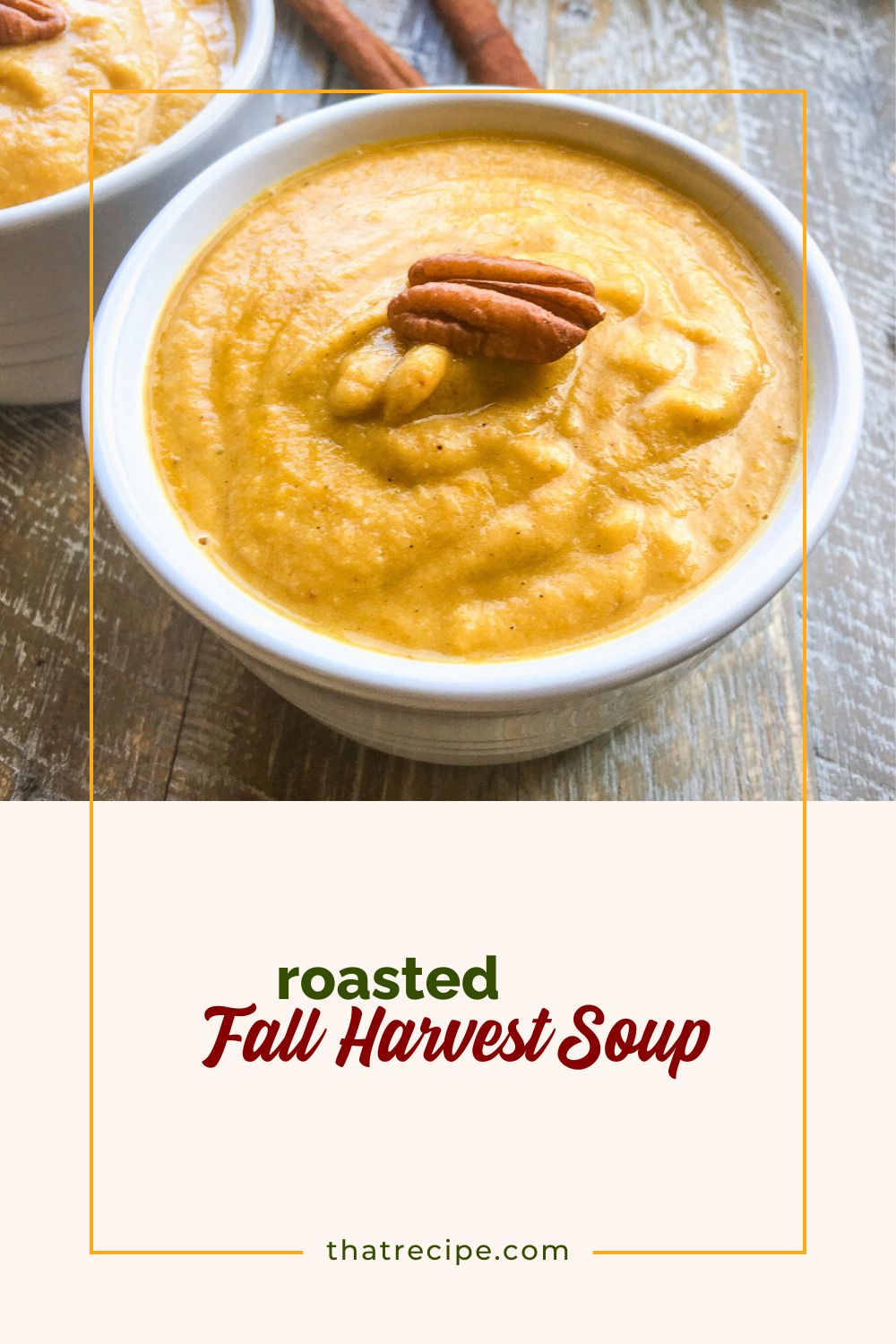 Bowl of pureed soup topped with a pecan
