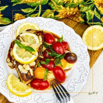 seared white fish with lemon and caprese salad on a plate