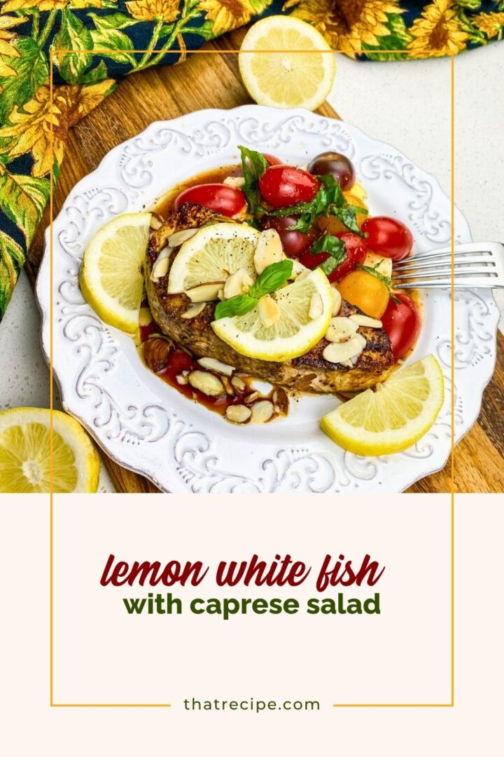 seared white fish with lemon and caprese salad on a plate