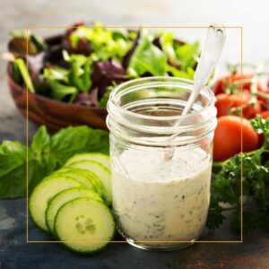 ranch dressing in a jar with a salad
