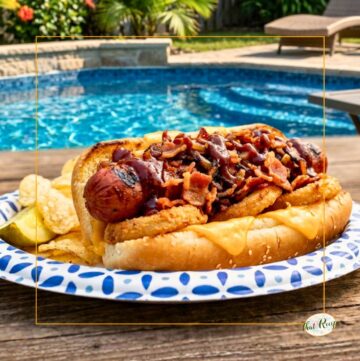 hot dog topped with bacon on a bun
