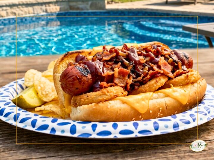 hot dog topped with bacon on a bun