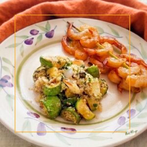 Summer Squash and Quinoa Pilaf or Salad on a plate with shrimp skewers.