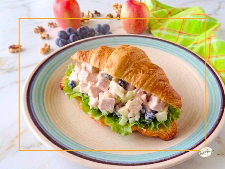 Waldorf chicken salad sandwich on a croissant.