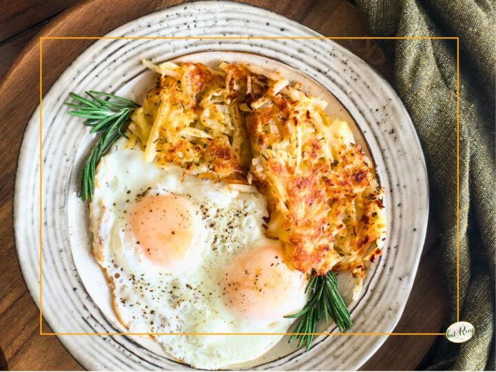 homemade hashbrowns on a plate with two eggs