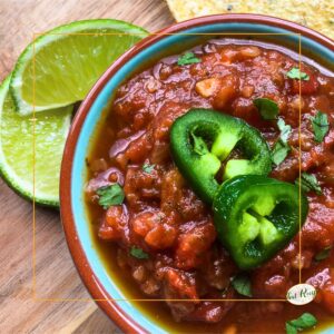 bowl of salsa topped with jalapeno slices