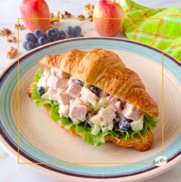 Waldorf chicken salad sandwich on a croissant.